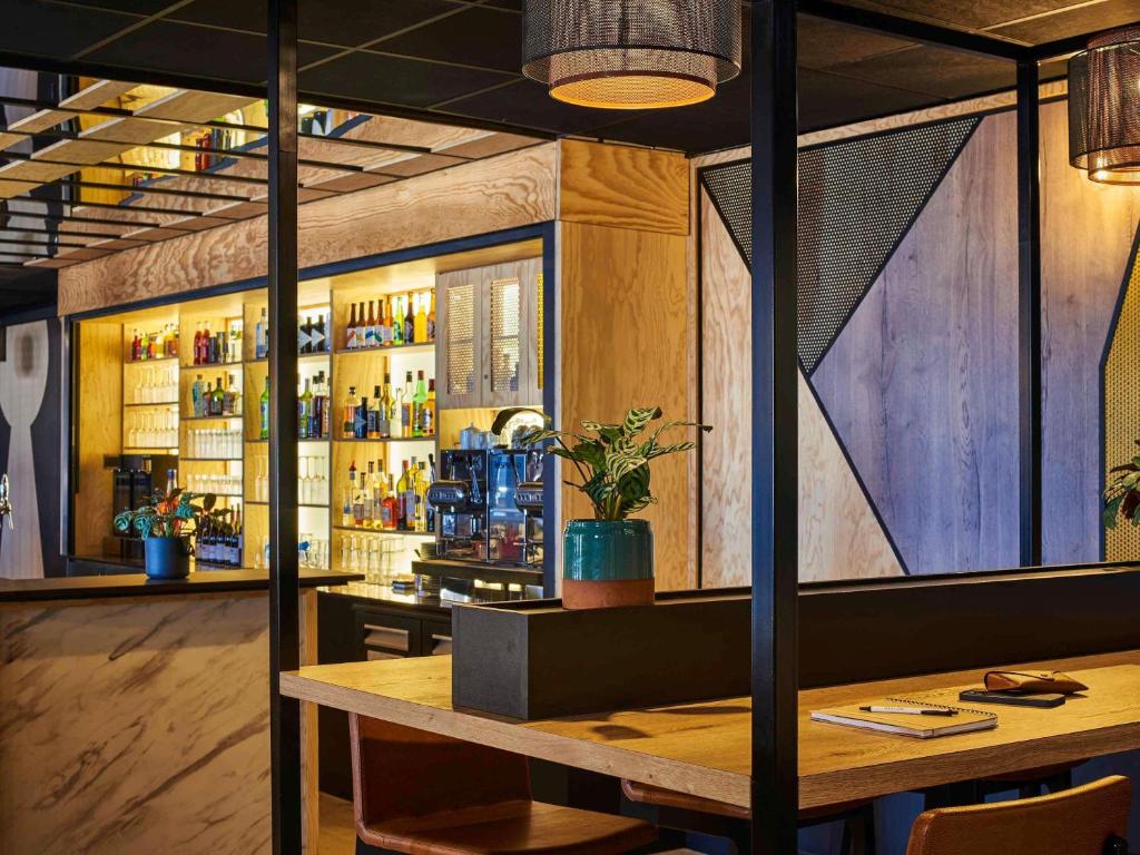 a bar with a wooden table in a room at Mercure Paris Gare De Lyon TGV in Paris