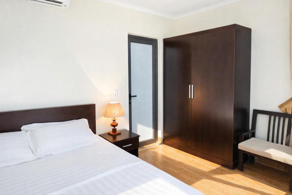 En eller flere senge i et værelse på Hà Tiên Motel