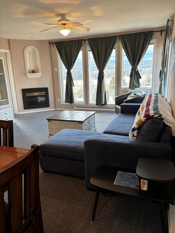 a living room with a bed and a couch at Cozy getaway with a view! in Fairmont Hot Springs