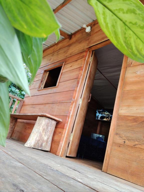 a wooden out house with a door in the middle at Cabaña Campestre - La Gloria in Guadalupe