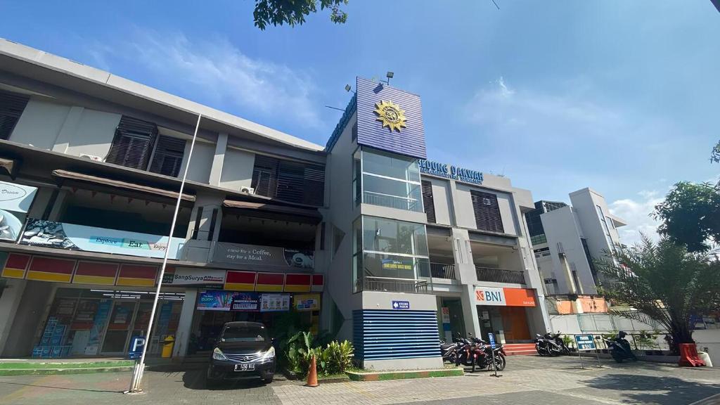 a building with a clock on the top of it at Sang Surya Guest House in Bandung