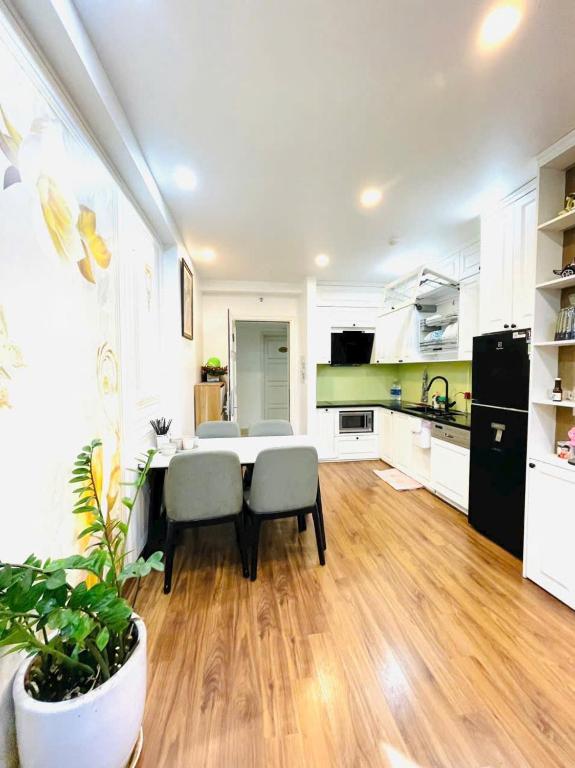 a kitchen with a table and chairs in a room at The Timegarden Homestay in Ha Long