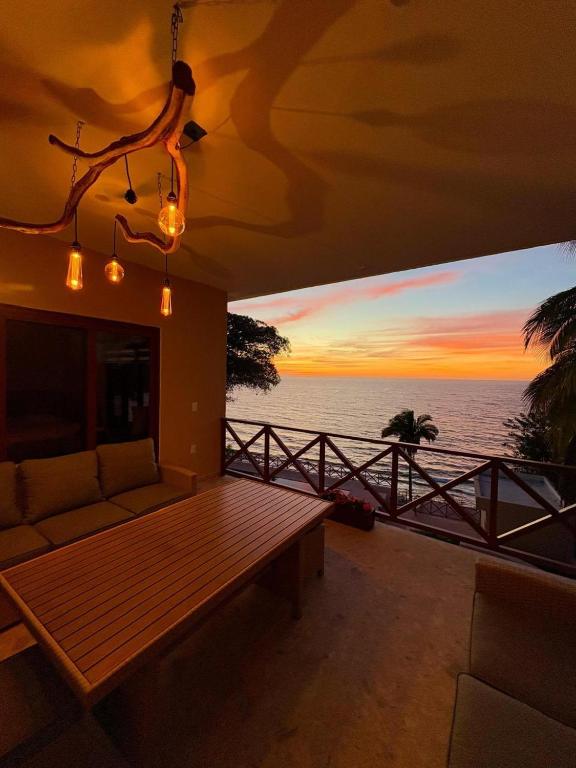 a living room with a couch and a view of the ocean at Mirador 28 in Platanitos