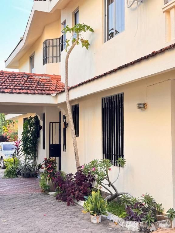 a house with a palm tree in front of it at 3Bedroom Villa-Shanzu, Mombasa in Mombasa