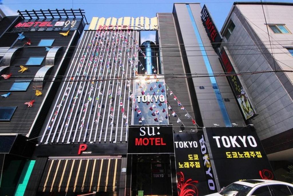a tall building with a sign that reads subway motel at SU Motel in Gumi