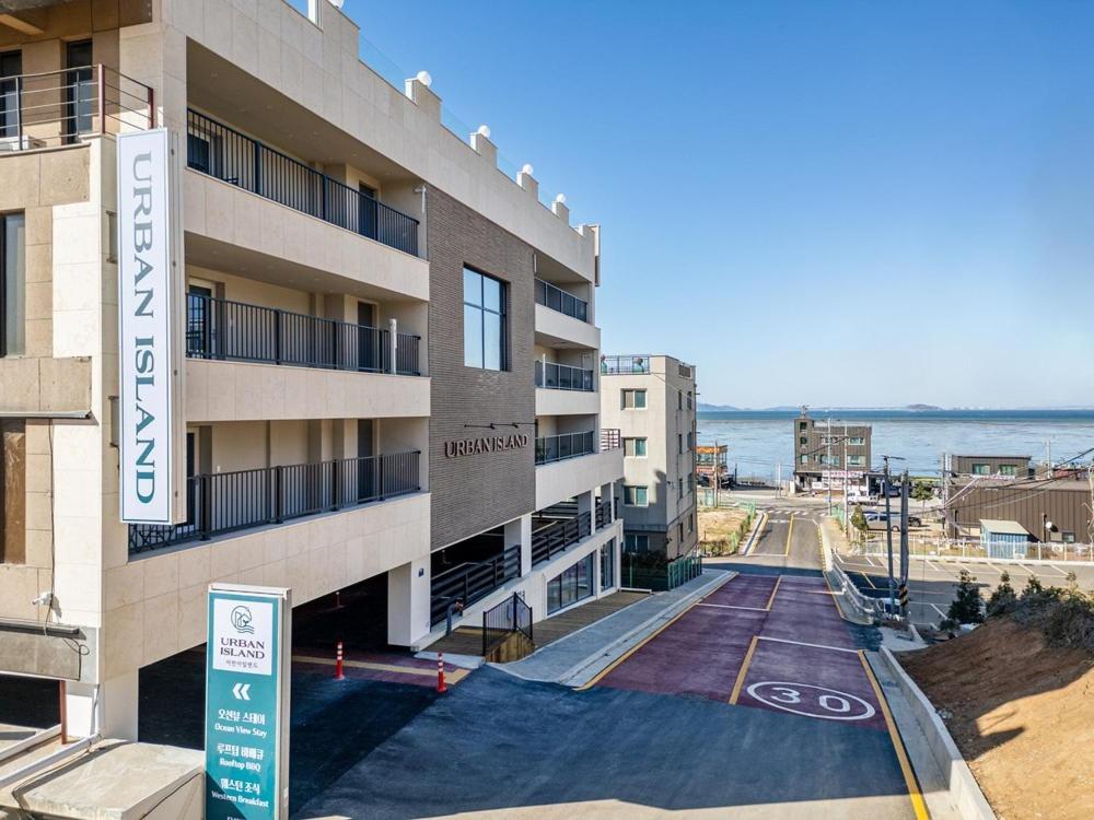 an apartment building with the ocean in the background at Daebudo Urban Island in Ansan