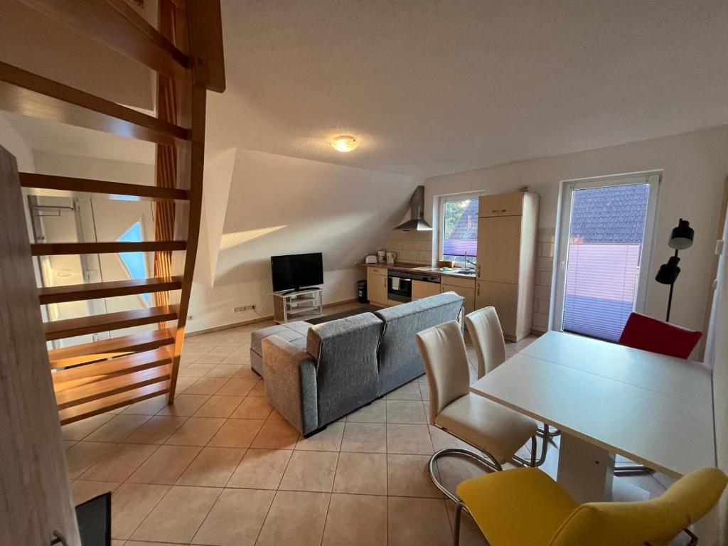 a living room with a table and a couch at Apartmenthaus Eldena Am Teich in Greifswald