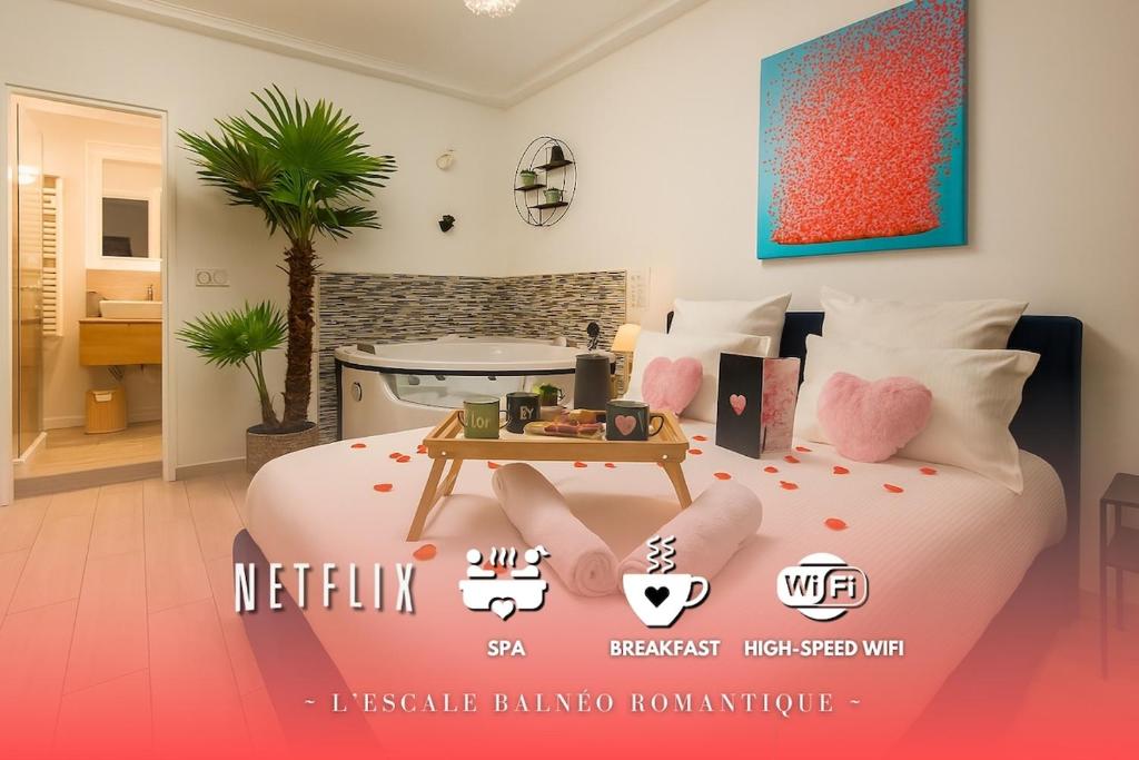 En eller flere senge i et værelse på L'Escale Balnéo'Romantique - Loveroom - Jacuzzi & Petit déjeuner
