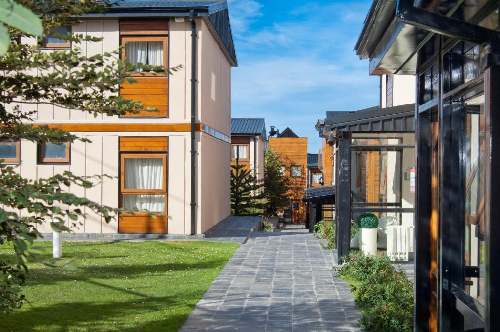 ein Haus mit einem Gehweg zwischen zwei Gebäuden in der Unterkunft Del Bosque Apart Hotel in Ushuaia