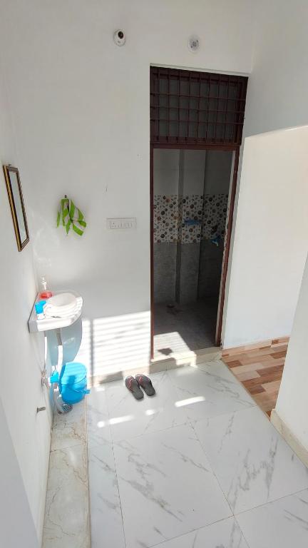 a room with a door and a sink and a toilet at Ajay homestay &PG in Jhūsi