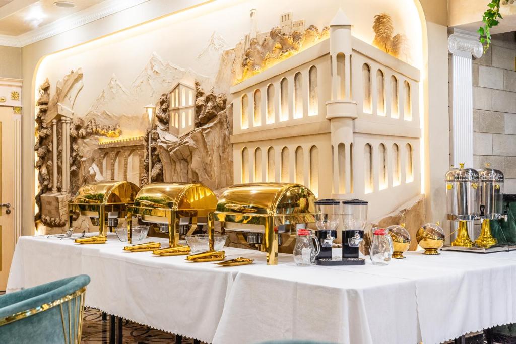 a table in a room with gold equipment on it at РИМ Garden in Almaty