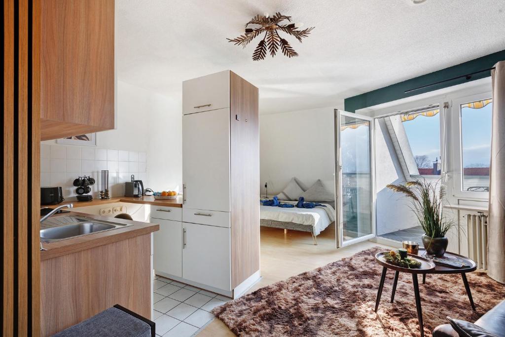 a kitchen with a sink and a table in a room at Domus Lux 404 in Bad Säckingen