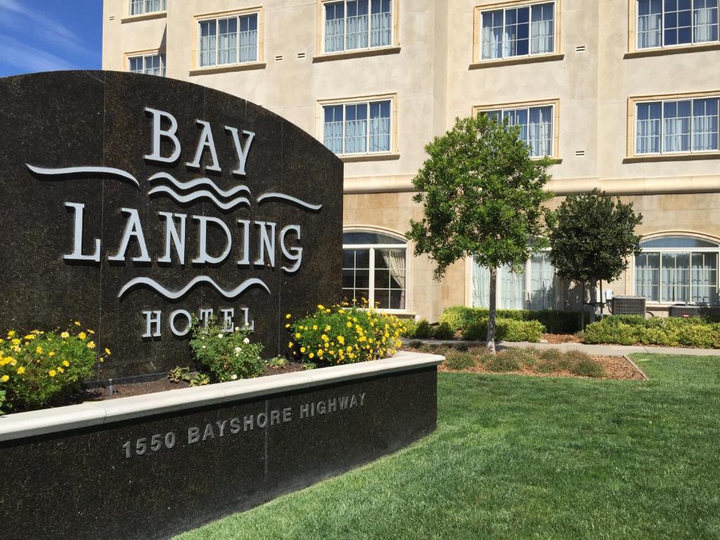a large brick building with a sign on the side of it at Bay Landing Hotel in Burlingame