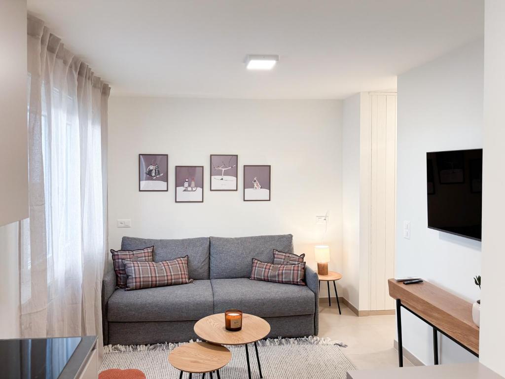 a living room with a couch and a table at Studio in central Crans-Montana in Crans-Montana