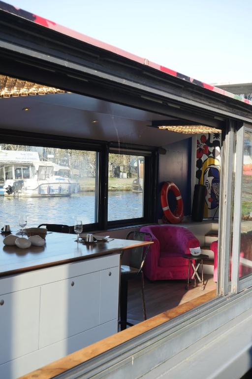 a kitchen and living room on a boat at Péniche ! Amours Le Dô Karina Bisch 2019 in Nantes