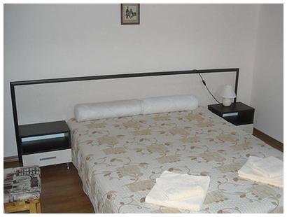 1 dormitorio con 1 cama con pared blanca en Guest rooms Voneshcha Voda, en Voneshta Voda