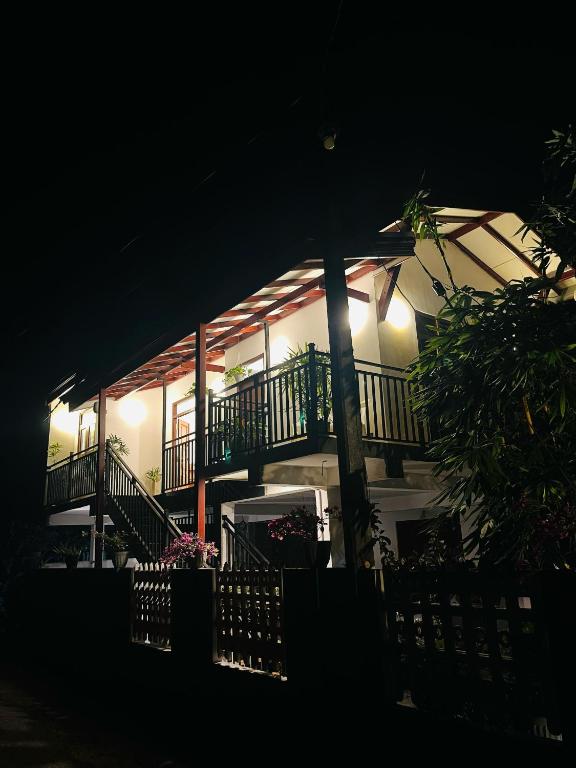 a lit up building with a balcony at night at Bliss Haven Transit Hotel in Negombo