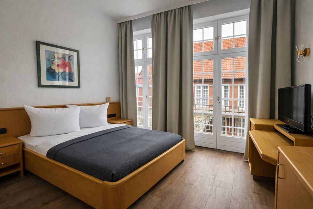 En eller flere senge i et værelse på Hotel Borchers