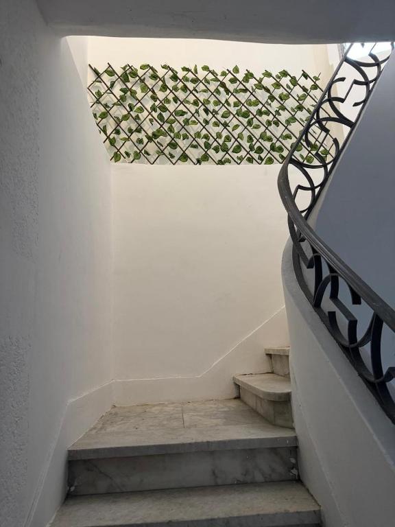 a set of stairs with a wrought iron railing at Apartment in Elshatby in Alexandria