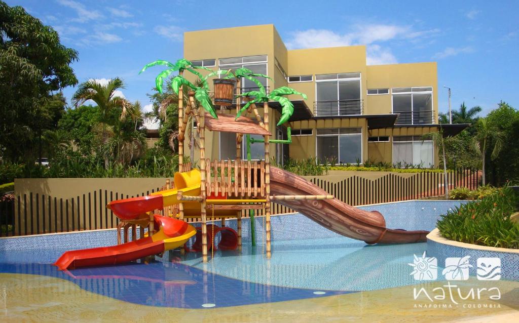 a playground in a swimming pool with a slide at Anapoima Natura in Anapoima