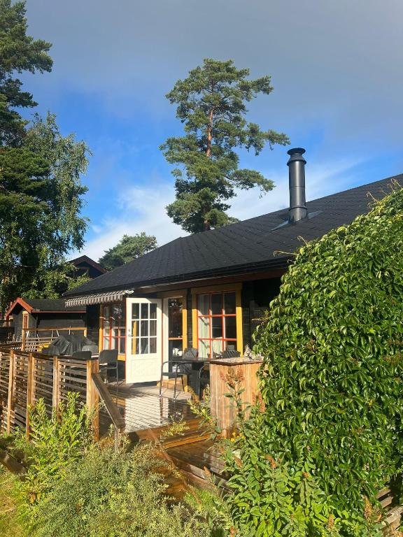 a small house with a porch and a fence at Tallbo24 in Klofsan