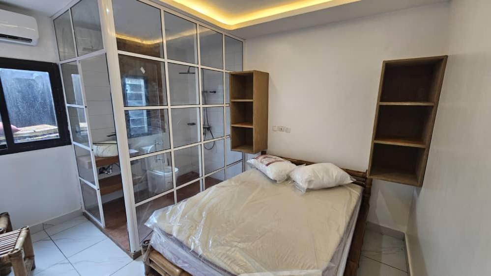 Ένα ή περισσότερα κρεβάτια σε δωμάτιο στο Ayooka Beach Residence Grand Bassam