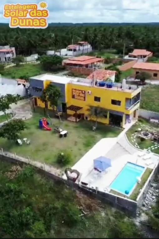 an aerial view of a building with a swimming pool at Estalagem Solar das Dunas in Pirambu
