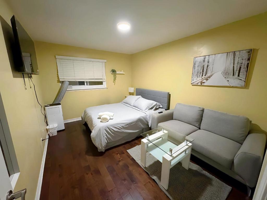 a small bedroom with a bed and a couch at Chapman H in Toronto