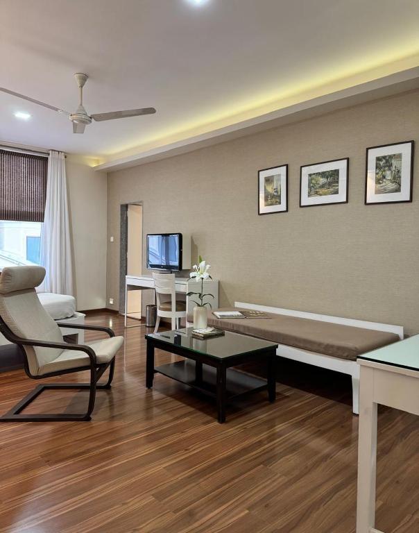 a living room with a couch and a tv at The Ketan in Pune