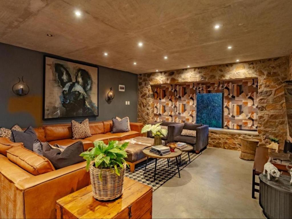 a living room with a couch and a table at Dombeya Private Game Reserve in Vaalwater