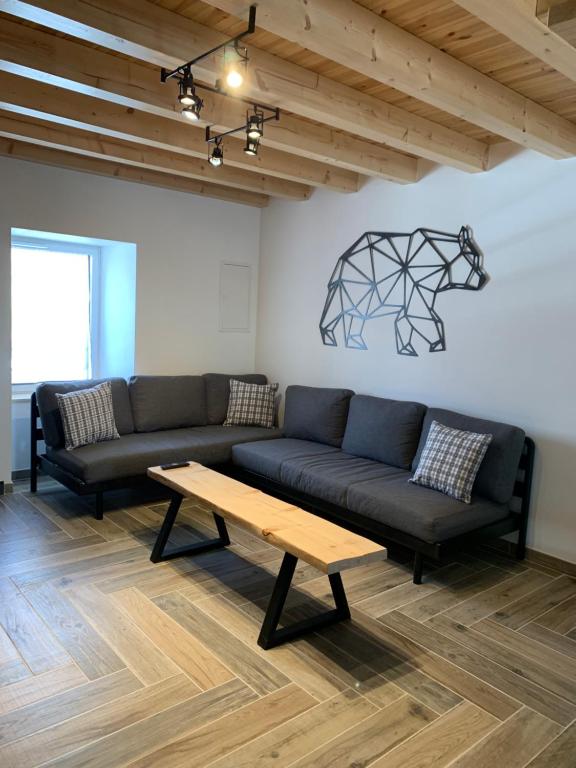 a living room with a couch and a coffee table at L'Ail des Ours in Les Estables