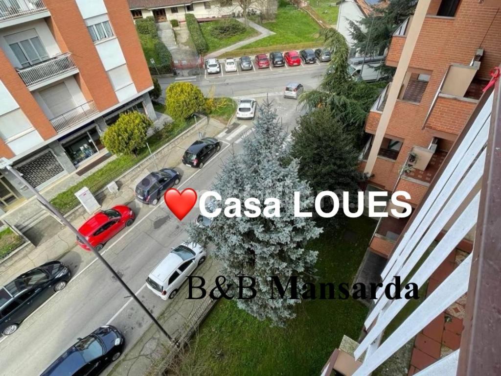 a view of a street with cars parked on the road at Casa LOUES in Asti
