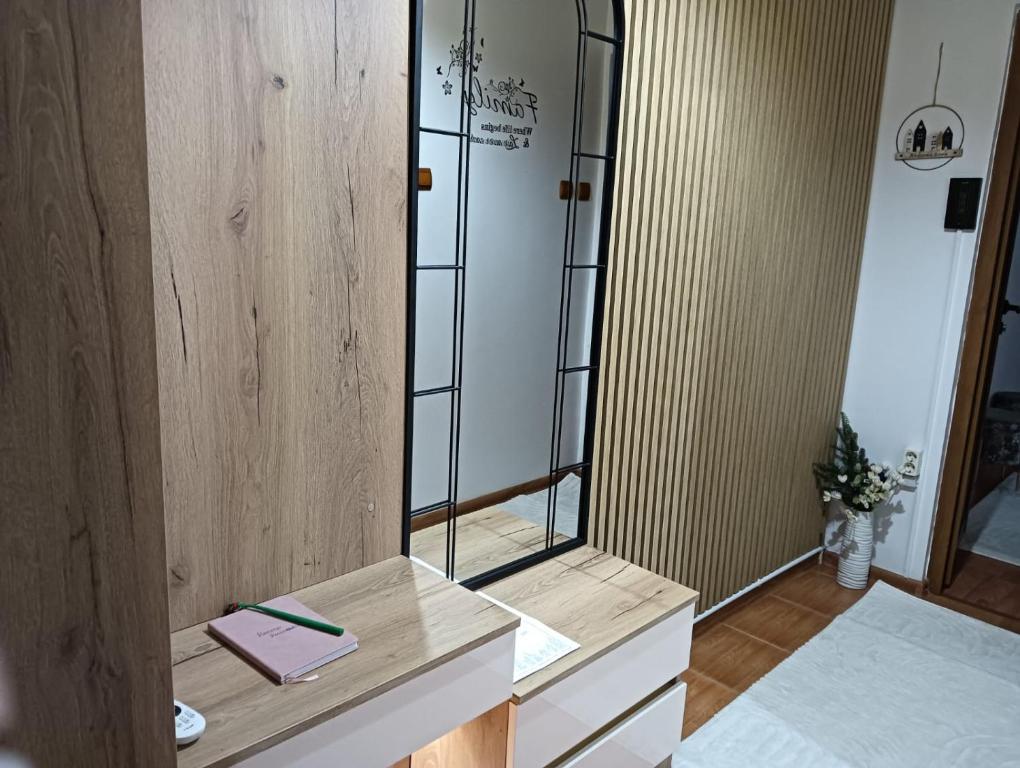 a bathroom with a mirror and a sink at La Montzi For4 in Craiova