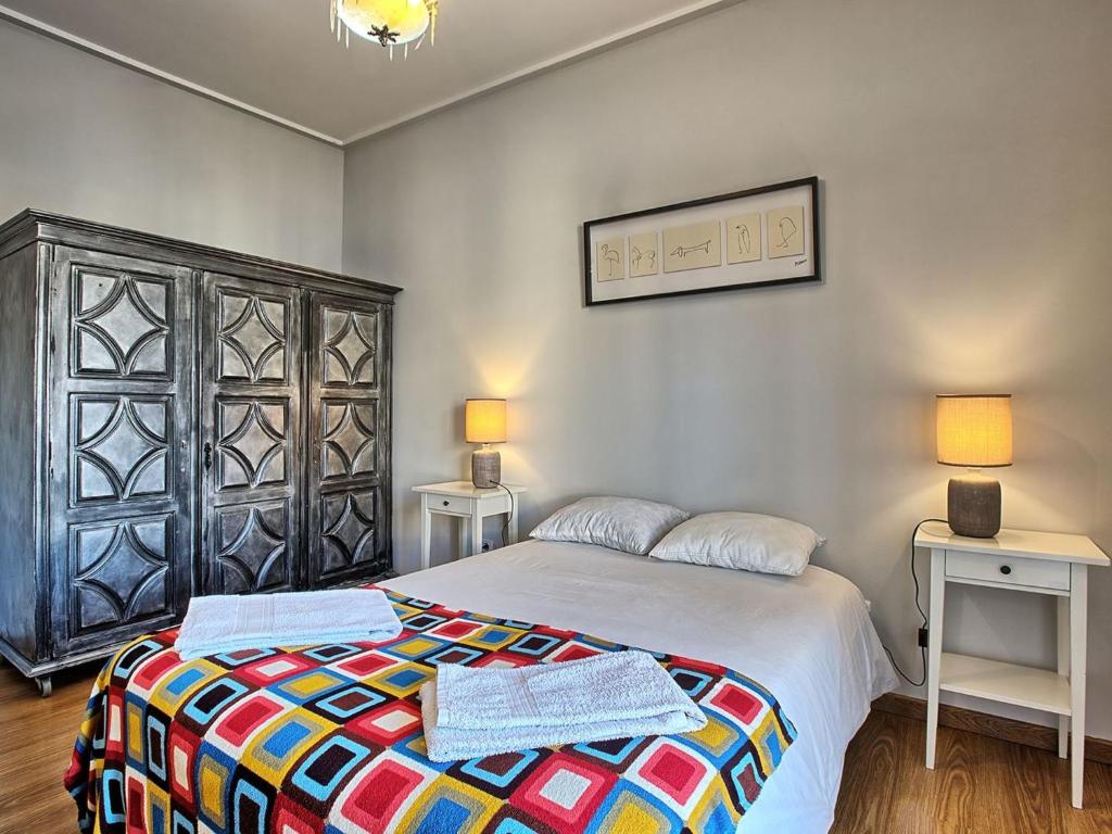 a bedroom with a bed and two tables and two lamps at Apartment Wunderschöner Paço D'Arcos by Interhome in Paço de Arcos