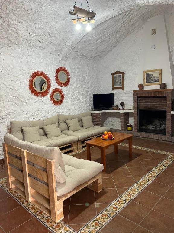 a living room with a couch and a fireplace at Bike Cueva - Los Coloraos in Gorafe