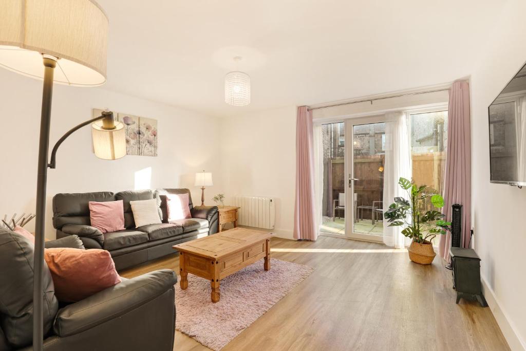 a living room with a couch and a table at Yeavering - North East Escapes in Wooler