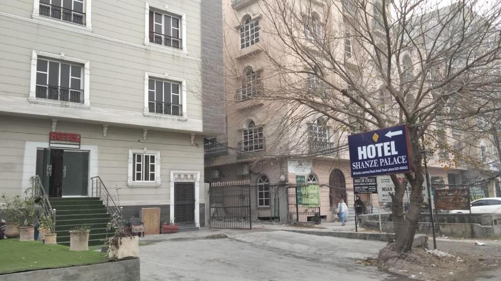 a hotel sign in front of a building at Hotel Shanze Palace in Lahore