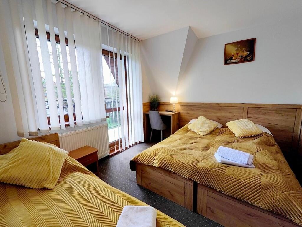 En eller flere senge i et værelse på Ośrodek Wypoczynkowy Baca