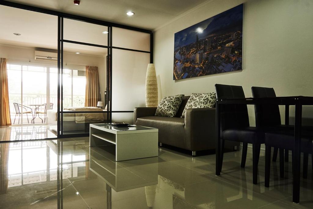 a living room with a couch and a table at Baan Klang Condo Hua Hin in Hua Hin