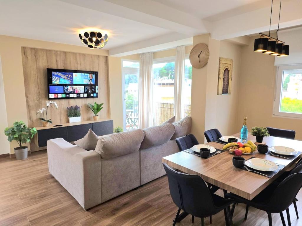 a living room with a table and a couch at Infinity Torremolinos Spacious 2 Bedroom, 2 Bathroom Apartment by NAMASTE ELITE in Torremolinos