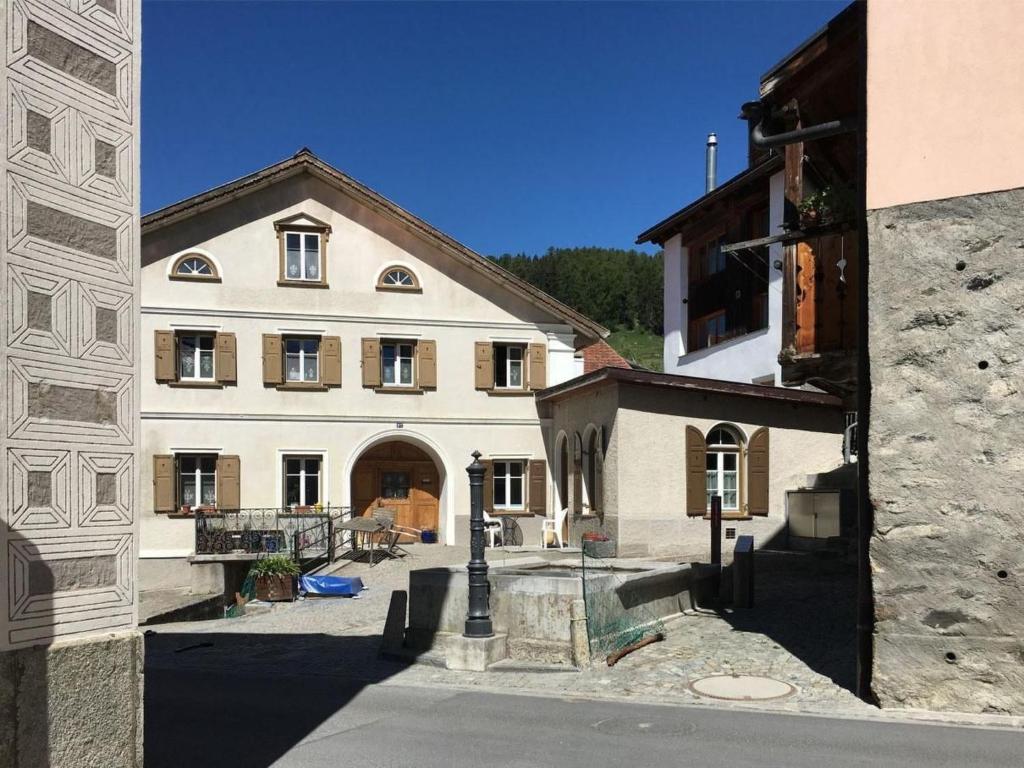 a large white building with a courtyard in front of it at Apartment cajos-ftan by Interhome in Ftan