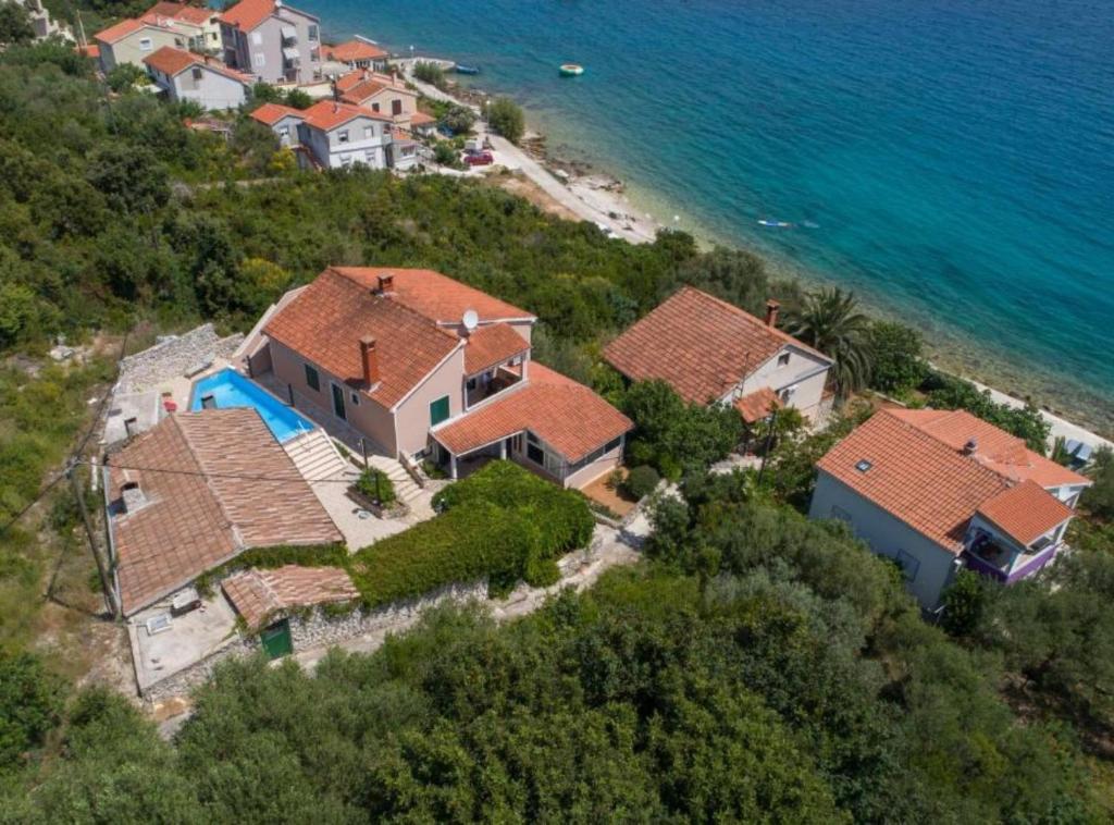 an aerial view of a house on a hill next to the ocean at Holiday Home Villa Rokov in Mali Iž