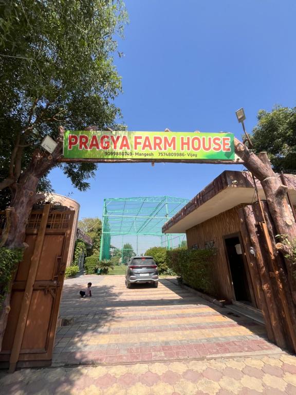 a car is parked in front of a farm house at Pragya Farmhouse in Jodhpur