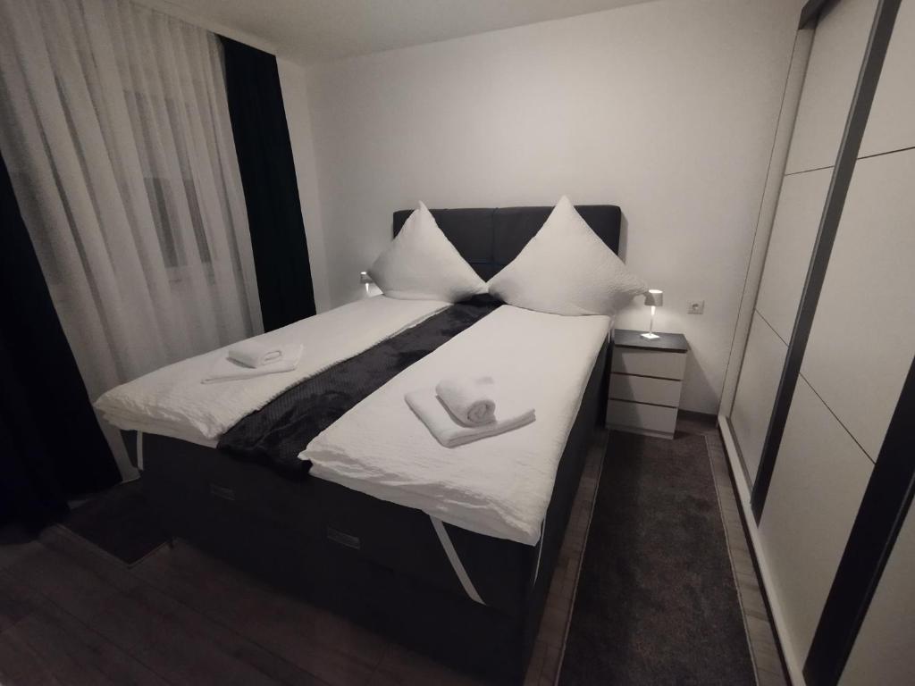 a bedroom with a bed with two towels on it at Old Town in Livno