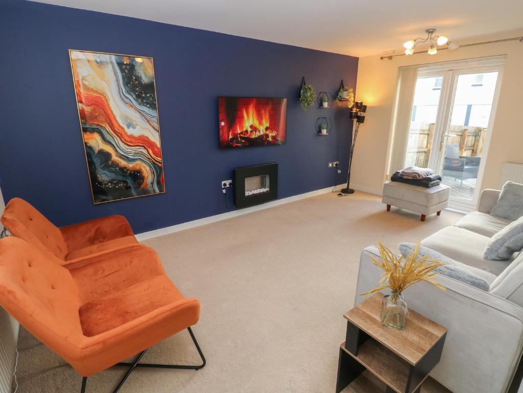 a living room with a couch and a fireplace at Swansea Escape in Swansea