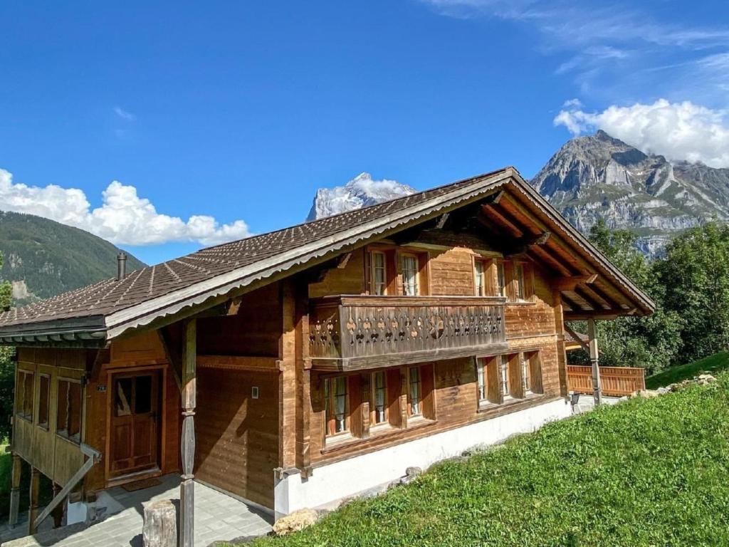 a wooden house with a balcony on a hill at Holiday Home Chalet Simeli by Interhome in Grindelwald
