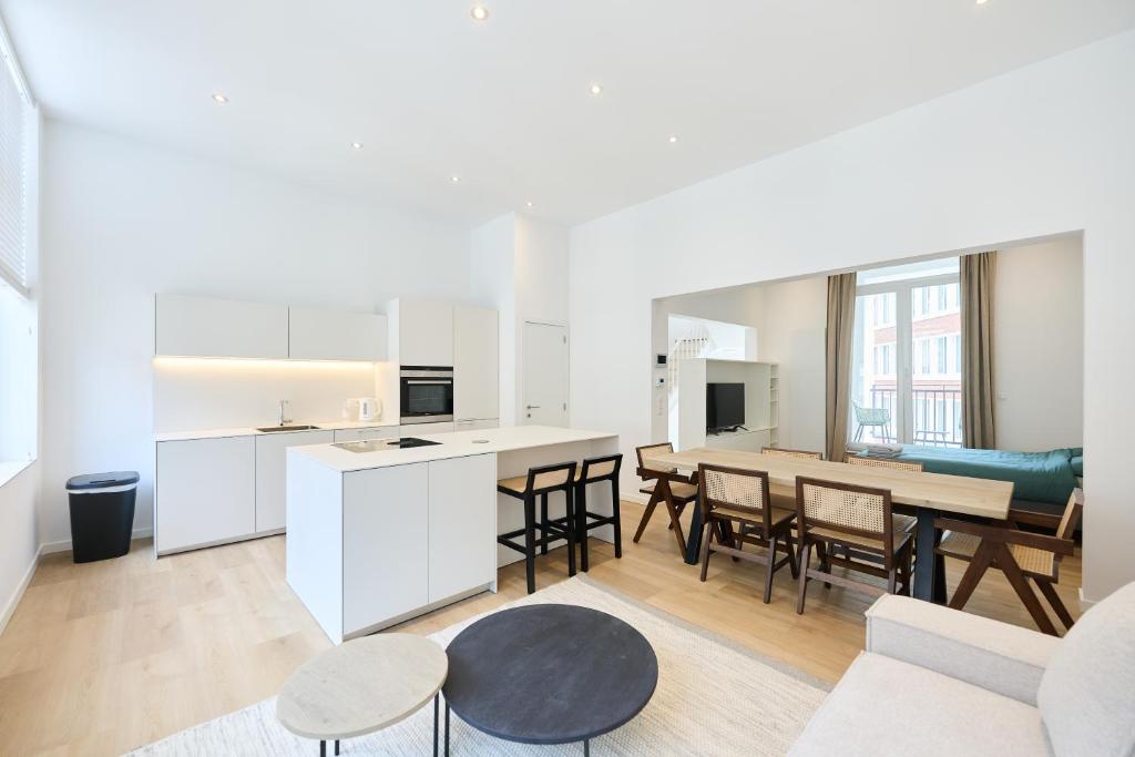 a kitchen and living room with a table and chairs at Toison d'Or House 4 in Brussels