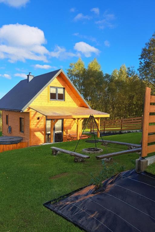 a house with a swing in the yard at Orawska Sielanka in Roztoki