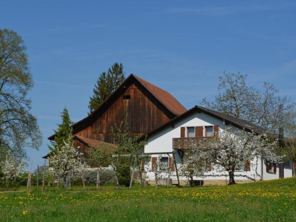 a large barn with a wooden roof at Apartment Wohnung Bellevue by Interhome in Chevenez