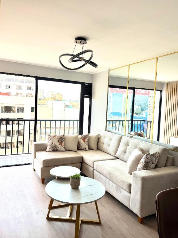 a living room with a couch and a table at Brand New Apartment in Lima